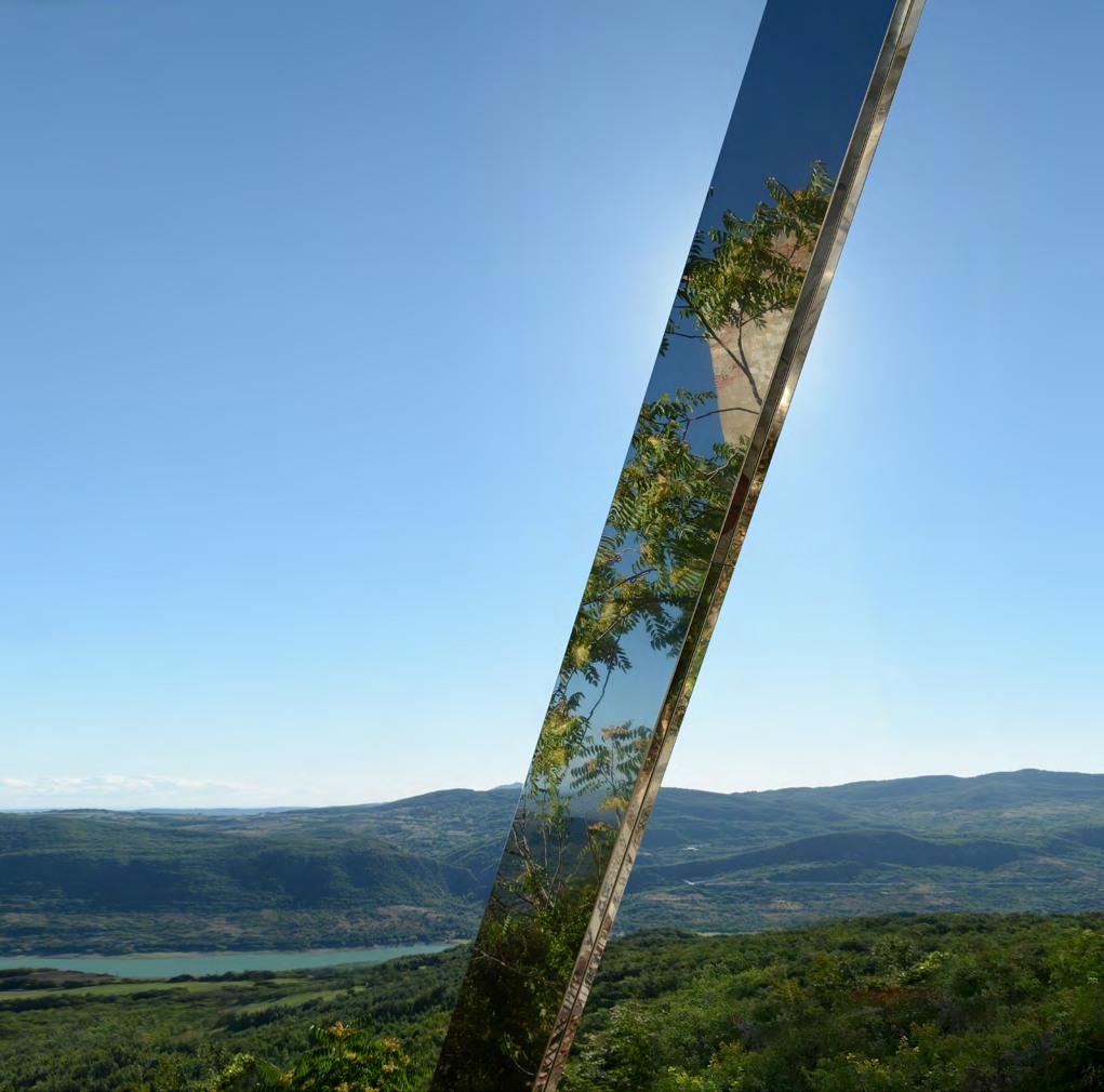 A monumental mirrored steel plane reflecting the landscape in Montebello sul Sangro